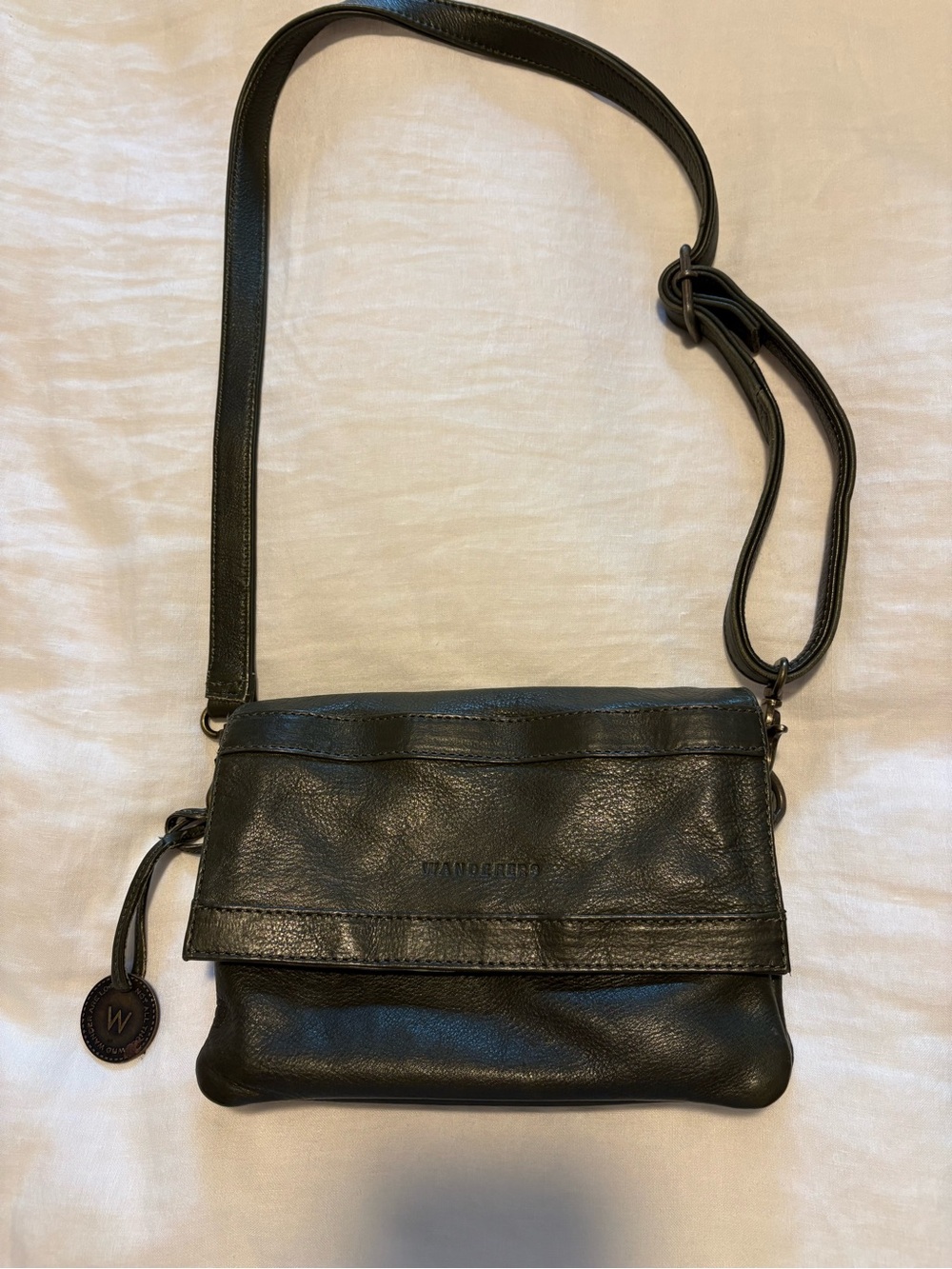 Wanderers Travel Co crossbody wristlet in olive green.